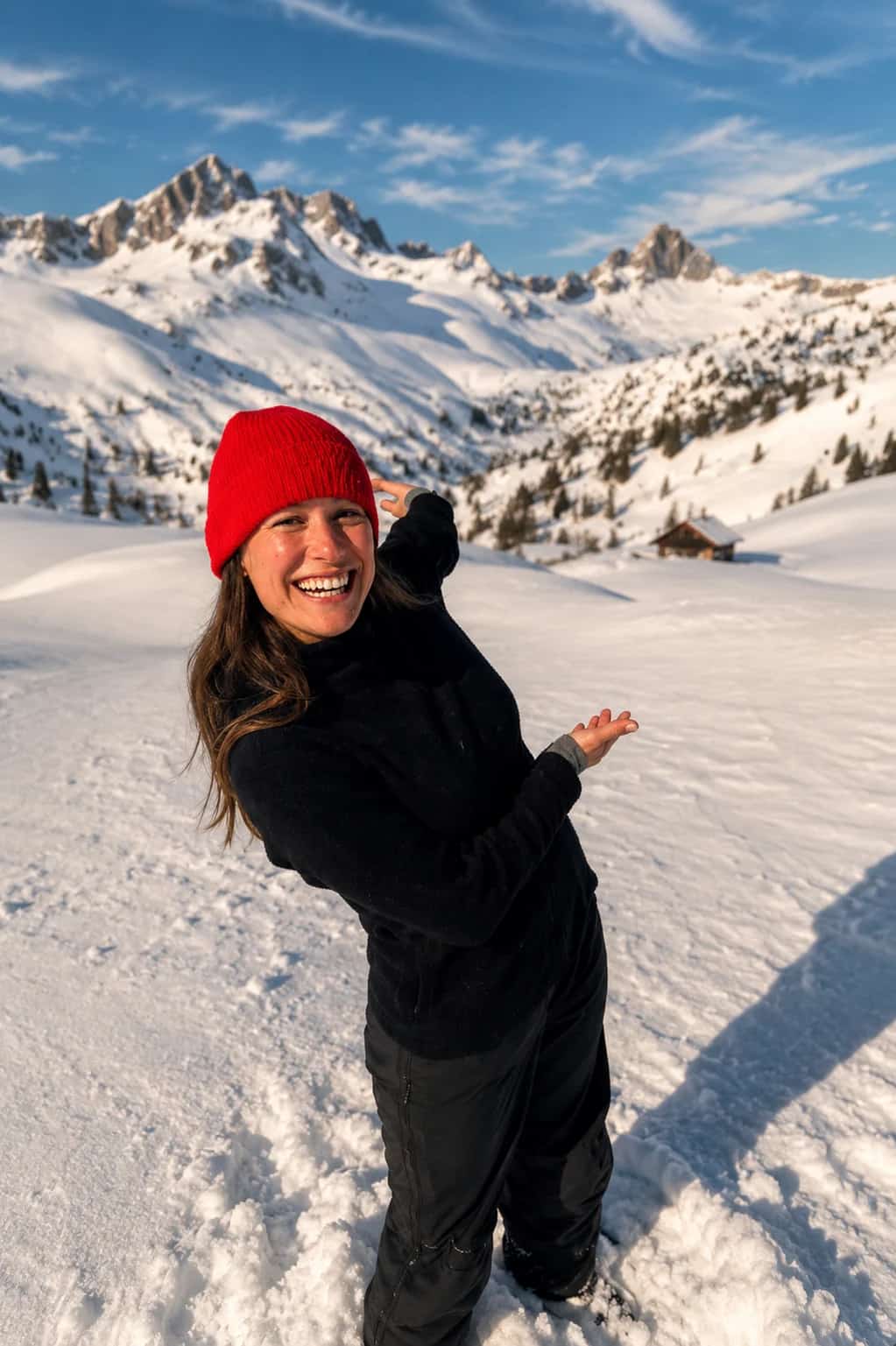 Francesca in the winter Dolomites, snow underfoot and the peaks behind her